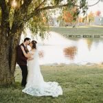 Wedding couple kissing next to a tree
